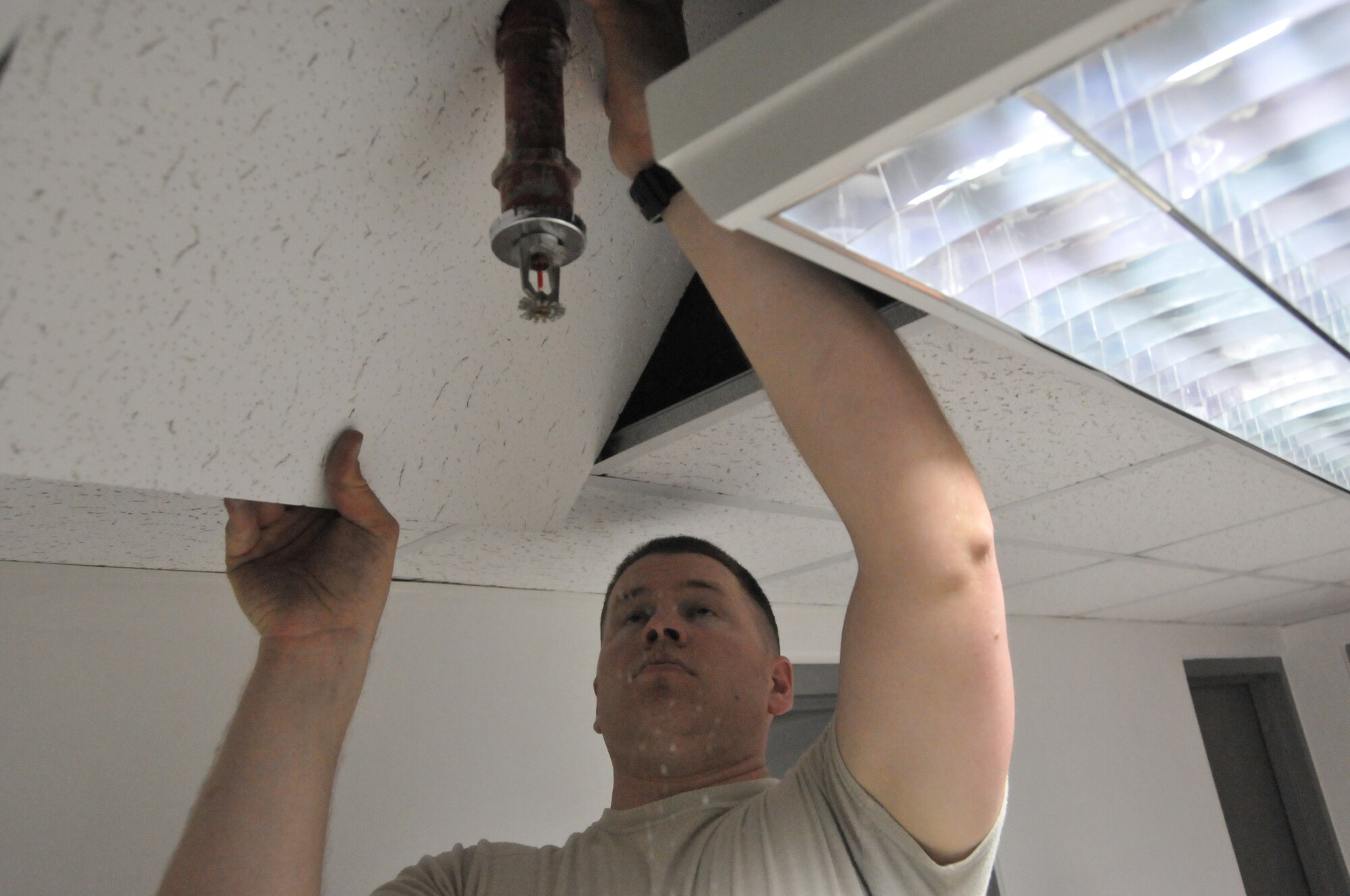 Staff Sgt. Matthew Morrish, 379th Expeditionary Civil Engineer Squadron structural specialist, replaces ceiling tiles in a Blatchford-Preston Complex dormitory Feb. 23 at Al Udeid Air Base, Qatar.  Morrish is the lead structural specialist on the BPC maintenance team.  He’s been a structural specialist for five years. (U.S. Air Force Photo by Tech. Sgt. Terrica Y. Jones)