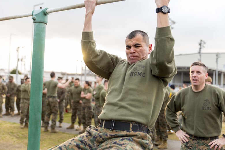 Gunnery Sgt. David Rubio, aviation ordnance chief with Headquarters and Headquarters Squadron, participates in a pull up event during the Frozen Chosin Competition at Marine Corps Air Station Iwakuni, Japan, Feb. 25, 2016. Teams consisting of six members completed a series of events including a pull up and sit up contest, a 5k supply run, a 600 meter swim, 250 meter sprint then constructing and presenting professional military education. The competition is set to resemble the rigorous struggles Marines faced during the battle of the Chosin Reservoir in 1950.