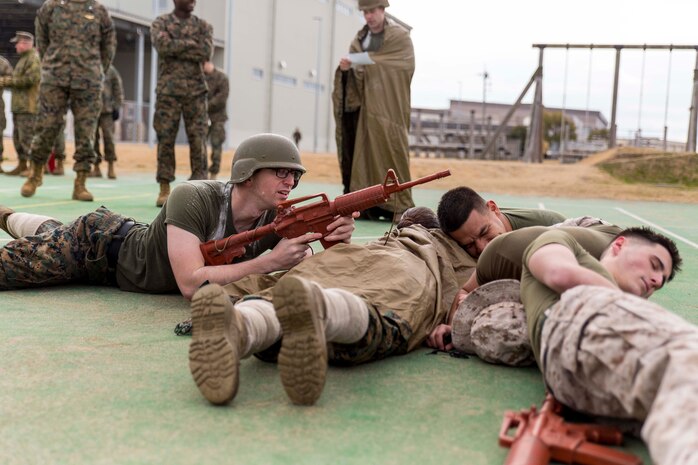 Marines with the provost marshal’s office accident investigation department demonstrate professional military education during the Frozen Chosin Competition at Marine Corps Air Station Iwakuni, Japan, Feb. 25, 2016. Teams consisting of six members completed a series of events including a pull up and sit up contest, a 5k supply run, a 600 meter swim, 250 meter sprint then constructing and presenting a PME. By testing physical endurance and strength throughout multiple consecutive events, the competition helps build morale, confidence and esprit de corps within the squadron.