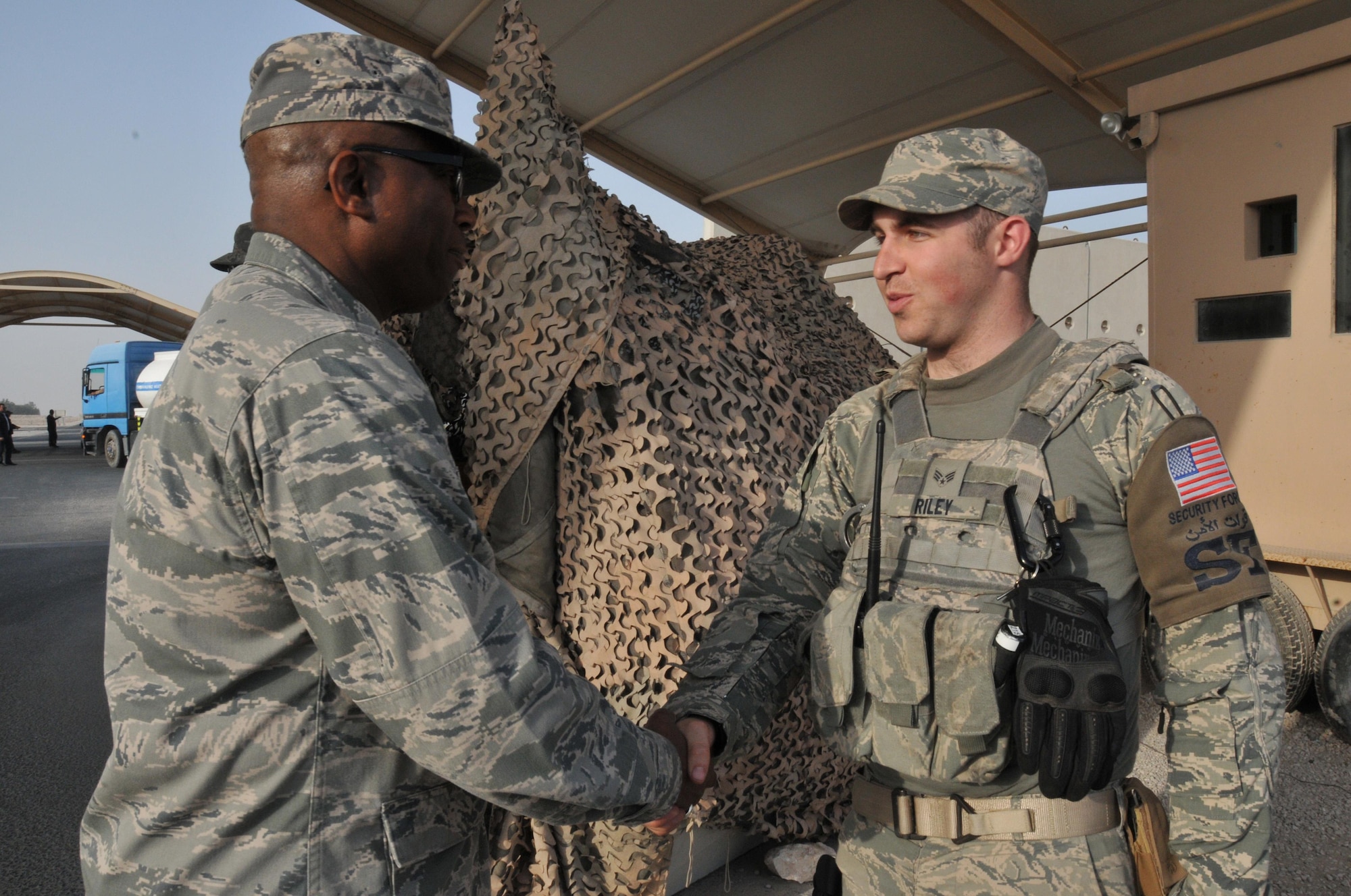 Brig. Gen. Allen Jamerson, director of Security Forces, talks with Senior Airman Bryan Riley, 379th Expeditionary Security Forces Squadron patrolman Feb. 24 at Al Udeid Air Base, Qatar. Jamerson talked with patrolman working the entry control point about their career and where they were deployed from. (U.S. Air Force Photo by Tech. Sgt. Terrica Y. Jones)
