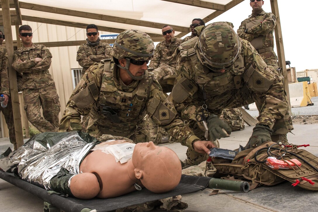 Army Capt. J.C. Devilla, right, and Army Capt. Chris Novits apply combat casualty care to a simulated patient at Camp Buehring, Kuwait, Feb. 22, 2016. Devilla is an aeromedical physician assistant to the California Army National Guard’s 640th Aviation Support Battalion, 40th Combat Aviation Brigade and Novits is assigned to the California Army National Guard’s 1st Battalion, 140th Aviation Battalion, 40th Combat Aviation Brigade. U.S. Army photo by Staff Sgt. Ian M. Kummer