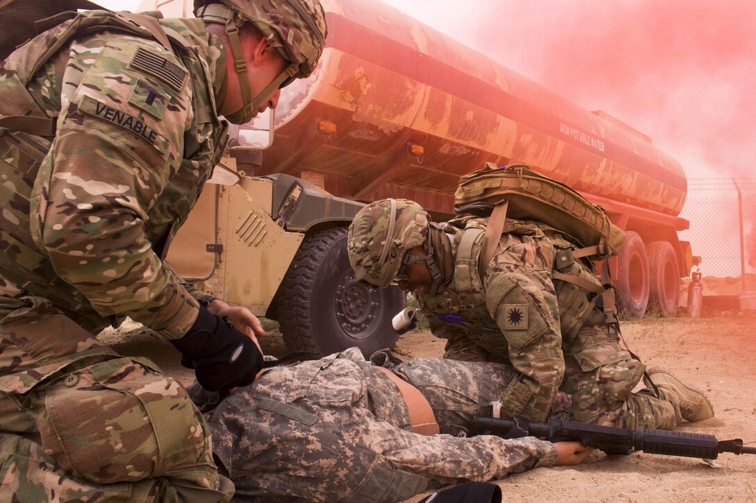 Army 1st Lt. Chuck Venable, left, and Army Sgt. Ravalene Butler treat a simulated patient at a tactical combat casualty care lane at Camp Buehring, Kuwait, Feb. 23, 2016. Venable is assigned to the California Army National Guard’s 10th Combat Support Hospital and Butler is an aviation medical specialist assigned to the California Army National Guard’s 1st Battalion, 140th Aviation Battalion, 40th Combat Aviation Brigade. U.S. Army photo by Staff Sgt. Ian M. Kummer