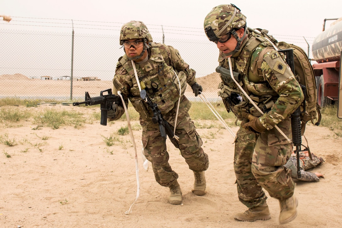 Army Sgt. Gerome Rodriguez, left, and Army Staff Sgt. Jose Sanchez evacuate a simulated patient at a tactical combat casualty care lane at Camp Buehring, Kuwait, Feb. 23, 2016. Rodriguez is a medical operations noncommissioned officer assigned to the California Army National Guard’s Headquarters Support Company, 640th Aviation Support Battalion, 40th Combat Aviation Brigade and Sanchez is assigned to the 40th Combat Aviation Brigade. U.S. Army photo by Staff Sgt. Ian M. Kummer