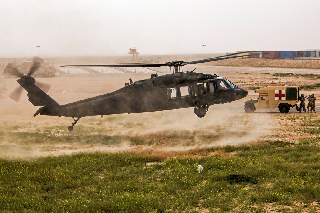 A UH-60 Black Hawk helicopter lands to evacuate a simulated patient from a tactical combat casualty care lane at Camp Buehring, Kuwait, Feb. 23, 2016. The helicopter crew is assigned to the California Army National Guard’s Company F, 2nd Battalion, 238th Aviation Regiment, 40th Combat Aviation Brigade. U.S. Army photo by Staff Sgt. Ian M. Kummer