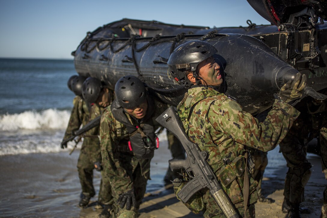 Japanese soldiers carry an F470 raiding craft off the beach during a landing exercise that's part of training for Exercise Iron Fist 2016 at Marine Corps Base Camp Pendleton, Calif., Feb. 24, 2016. U.S. Marine Corps photo by Lance Cpl. Ryan Kierkegaard