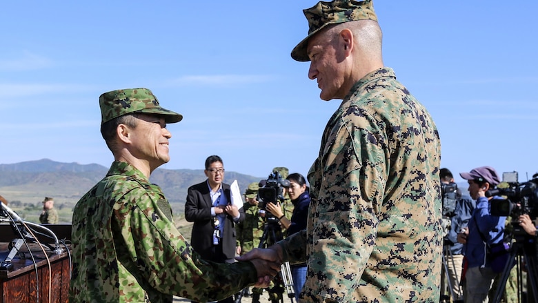 Brig. Gen. David Coffman, deputy commanding general, I Marine Expeditionary Force, shakes hands with Maj. Gen. Shinichi Aoki, deputy chief of staff (operations), Western Army, Japan Ground Self-Defense Force, after addressing media during a press conference at the amphibious landing exercise for Exercise Iron Fist 2016. PHIBLEX is a ship-to-shore landing exercise involving U.S. Marines, sailors and Japanese Soldiers, launched from the USS Somerset, onto the beaches of Marine Corps Base Camp Pendleton. Iron Fist enhances Japan Ground Self Defense Force and the U.S. Marine Corps’ ability to plan, communicate and conduct amphibious operations at the platoon, company and battalion levels.
