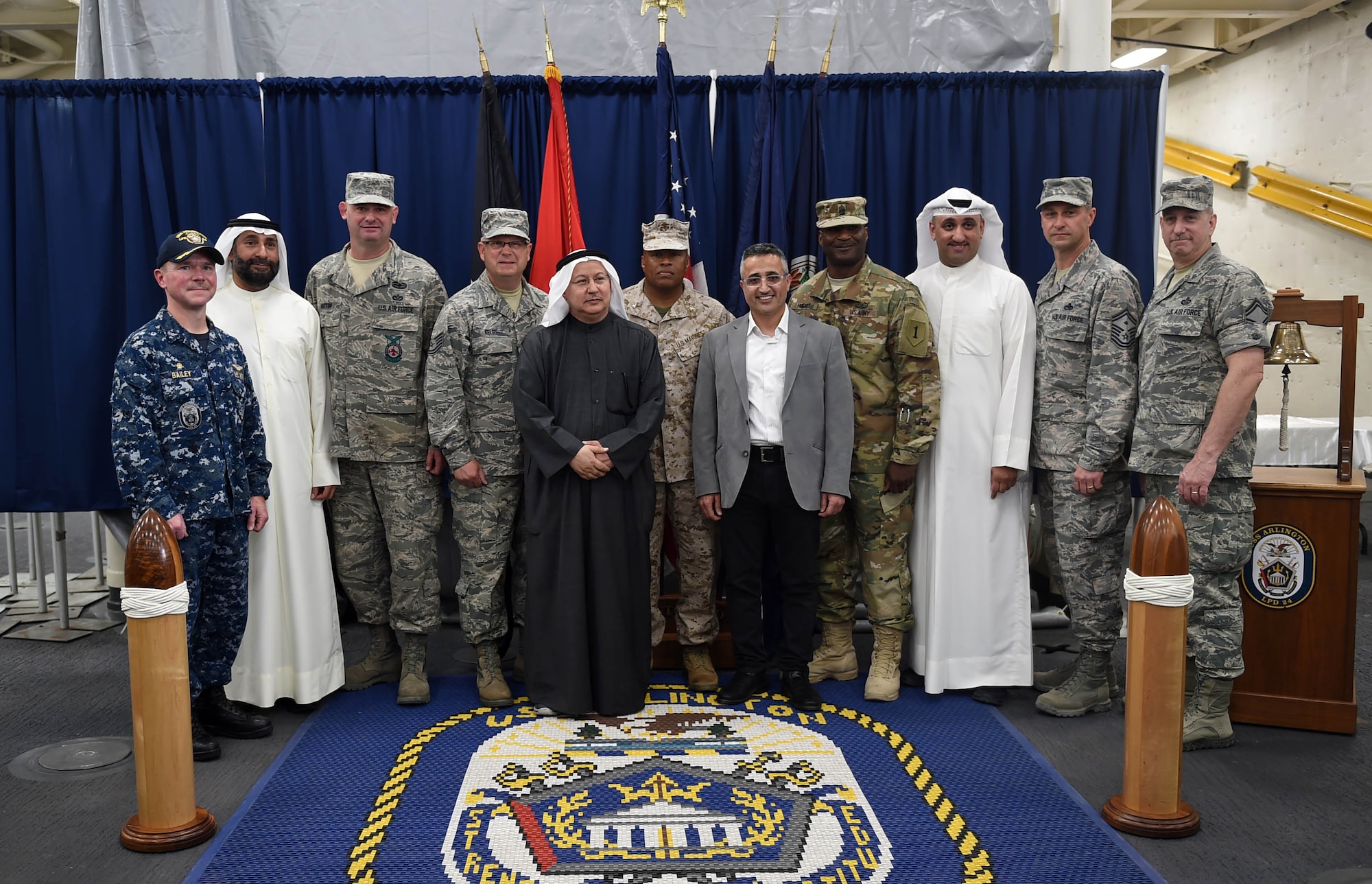 U.S. and Kuwaiti Gulf War veterans pose for a photo aboard the USS Arlington (LPD 24)during a ceremony celebrating the 25th Anniversary of the Liberation of Kuwait in Kuwait, Feb. 23, 2016. The veterans were invited to the ceremony during which they were presented a book commemorating U.S. and Kuwaiti service members’ efforts leading to the country’s liberation. (U.S. Air Force photo by Staff Sgt. Jerilyn Quintanilla)