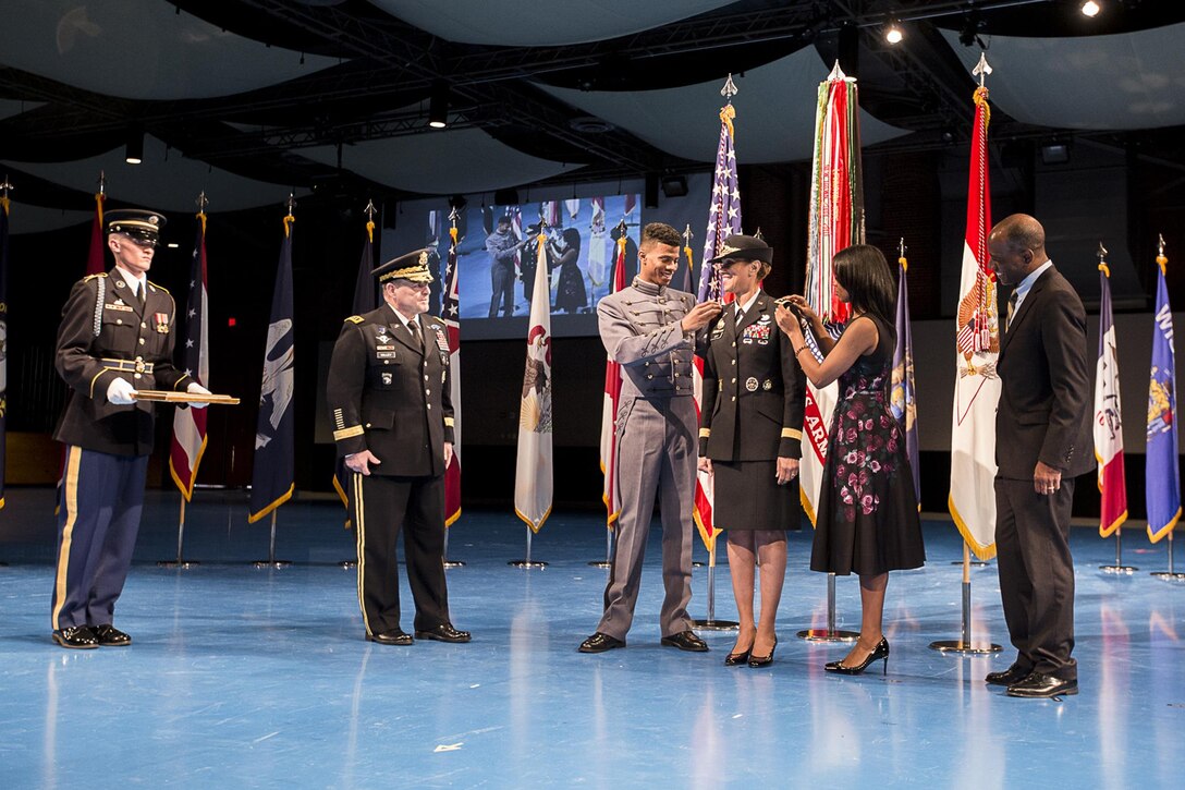 U.S. Army Lt. Gen. Nadja West, center, has her current rank insignia pinned on during her promotion ceremony Feb. 9 on the Fort Myer portion of Joint Base Myer-Henderson Hall by her son, Logan, left, and daughter, Sydney, right. West’s husband, retired U.S. Army Col. Donald West, far right, and U.S. Army Chief of Staff Gen. Mark A. Milley, left, watch. Milley promoted and swore in West to her current rank in the evening ceremony. West is the Army’s 44th surgeon general and commanding general for U.S. Army Medical Command. (Joint Base Myer-Henderson Hall PAO photo by Nell King)