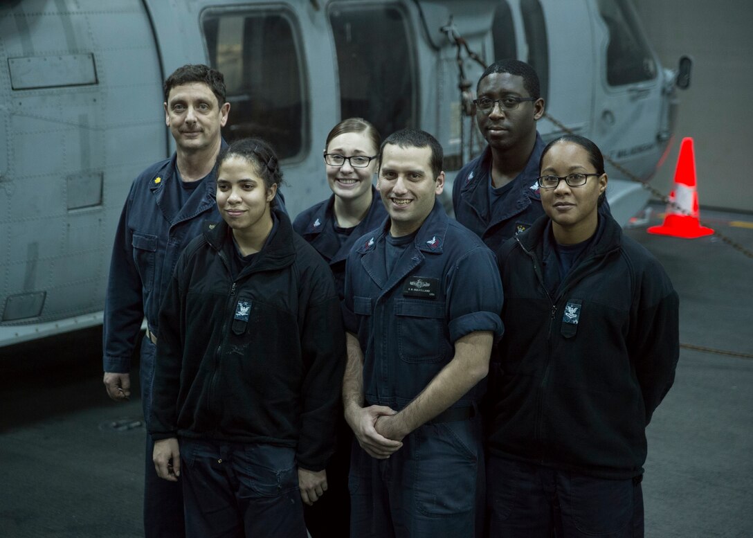 160223-N-TH560-010
PACIFIC OCEAN (February 24, 2016) – Aerographer’s Mate 1st Class Shawn Mulholland stands amongst the Meteorological and Oceanographic Team  (METOC) in the hangar bay aboard amphibious assault ship USS Bonhomme Richard (LHD 6). Bonhomme Richard is the lead ship of the Bonhomme Richard Amphibious Ready Group and is slated to participate in amphibious integration training (AIT) and a certification exercise (CERTEX) with the embarked 31st MEU. (U.S. Navy photo by Mass Communication Specialist 3rd Class Jeanette Mullinax/Released)
