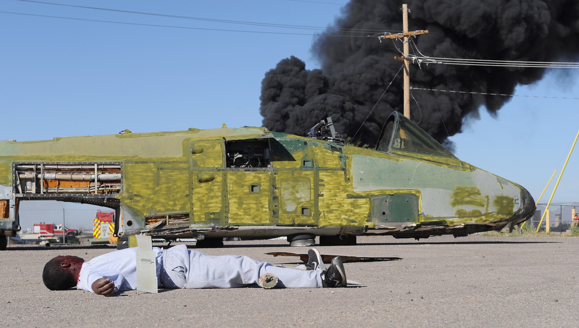 Mock aircraft crash victims yell for assistance during the BUSHWHACKER 16-02 Aircraft Crash emergency management exercise at Davis-Monthan Air Force Base, Ariz., Feb. 24, 2016. To help create a realistic crash scene for the exercise, the Inspector General and Investigations office used a retired A-10A thunderbolt II from the 309th Aerospace Maintenance and Regenerations Group.  (U.S. Air Force photo by Senior Airman Cheyenne A. Powers/ Released)