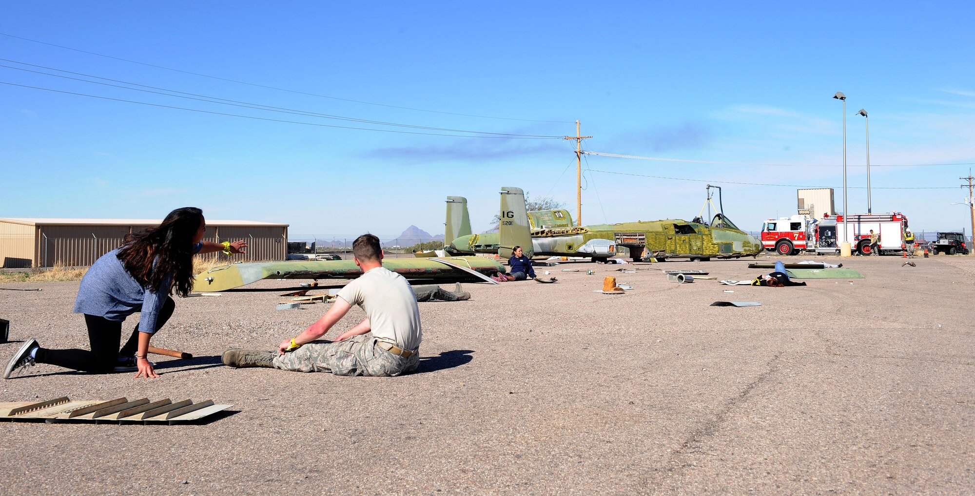 Airmen volunteer as simulated aircraft crash victims during the BUSHWHACKER 16-02 Aircraft Crash emergency management exercise at Davis-Monthan Air Force Base, Ariz., Feb. 24, 2016. The scenario for the exercise involved an A-10 that crashed into a crowd of people which allowed units for the upcoming air demonstrations. (U.S. Air Force photo by Senior Airman Cheyenne A. Powers/ Released)