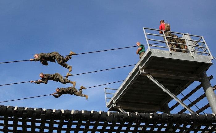 Recruits of Alpha Company, 1st Recruit Training Battalion, participate in the Slide for Life obstacle during Confidence Course II at Marine Corps Recruit Depot San Diego, Feb. 23. This obstacle required great physical endurance for recruits to keep their grip on the cable and make it through without falling. Annually, more than 17,000 males recruited from the Western Recruiting Region are trained at MCRD San Diego. Alpha Company is scheduled to graduate April 22.