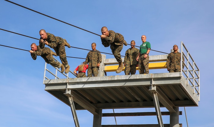 Recruits of Alpha Company, 1st Recruit Training Battalion, participate in the Slide for Life obstacle during Confidence Course II at Marine Corps Recruit Depot San Diego, Feb. 23. This obstacle required recruits to climb a 25-foot tower and slide down a 90-foot cable above a pool of water. Annually, more than 17,000 males recruited from the Western Recruiting Region are trained at MCRD San Diego. Alpha Company is scheduled to graduate April 22.