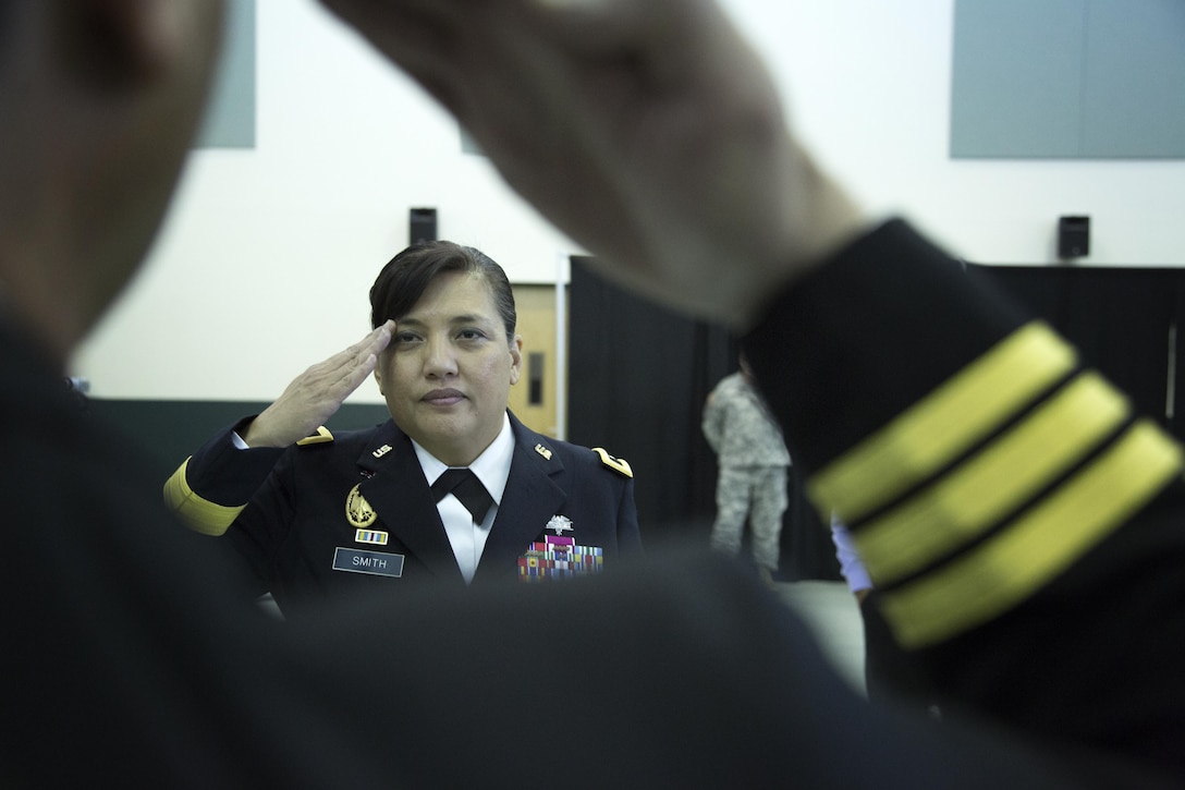 U.S. Army Reserve Brig. Gen. Tracy L. Smith, the newest AMEDD Brigadier General, and the first Guamanian/Chamorro female general officer in the Armed Forces, returns a salute from her brother, U.S. Navy Reserve Cmdr. (Ret.) Anthony Artero during the promotion ceremony held at the C.W. Bill Young Armed Forces Reserve Center in Pinellas Park, Florida Jan. 24, 2016. (U.S. Army photo by Spc. Tracy McKithern/Released)