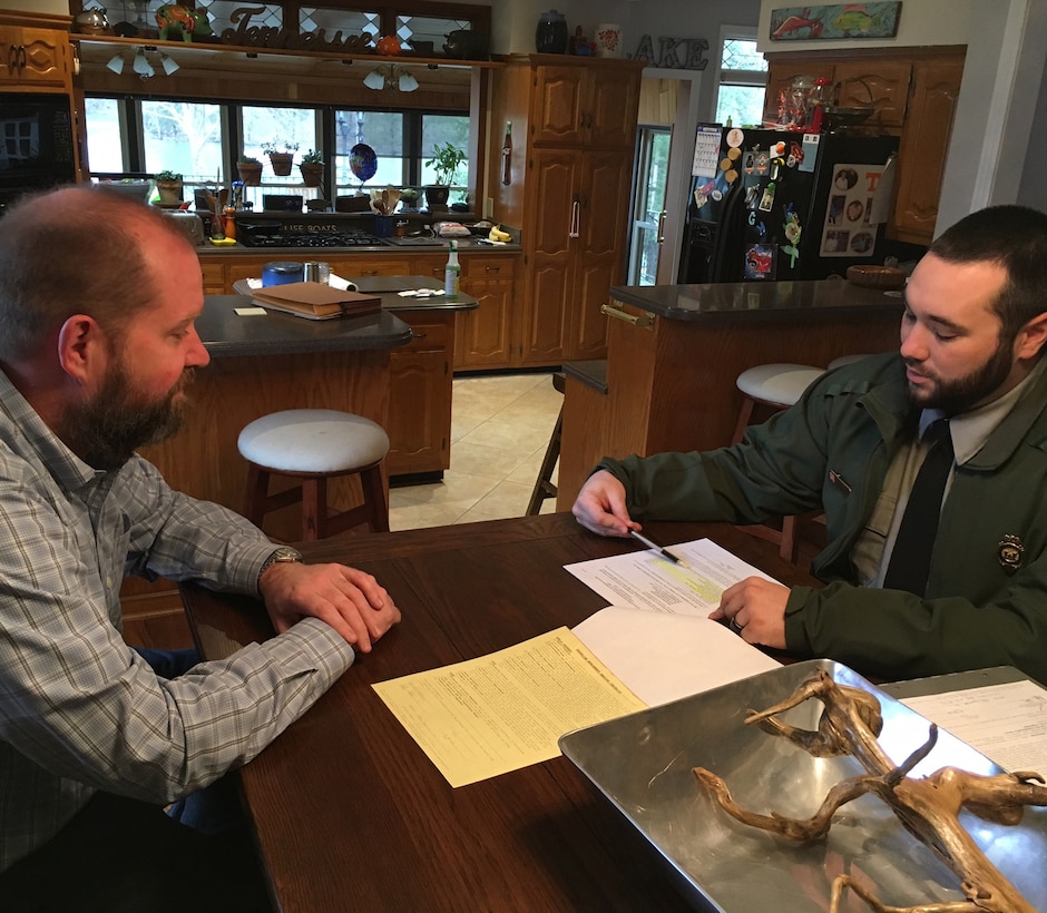 Old Hickory Lake Park Ranger Dylon Anderson meets with an adjacent landowner to discuss his shoreline license on March 16, 2016.  