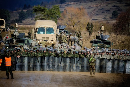 Soldiers of the Albanian Army partnered with Soldiers of 1st Battalion, 41st Infantry Regiment, 4th Infantry Division, prepare to deploy riot control forces, Feb. 25 at the Joint Multinational Readiness Center. The CRC event is part of an intense training cycle intended to prepare Soldiers for their pending KFOR deployment. 