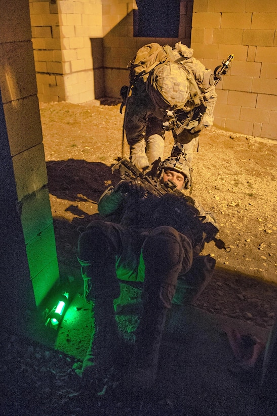A soldier evacuates a simulated casualty during a clearance operation exercise in a mock town at the National Training Center, Fort Irwin, Calif., Feb. 18, 2016. U.S. Army photo by Staff Sgt. Alex Manne