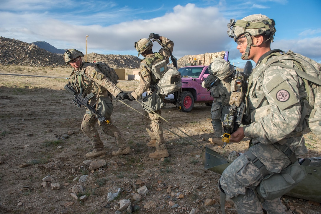 Soldiers evacuate a casualty during a clearance operation exercise in a mock town at the National Training Center, Fort Irwin, Calif., Feb. 18, 2016. U.S. Army photo by Staff Sgt. Alex Manne