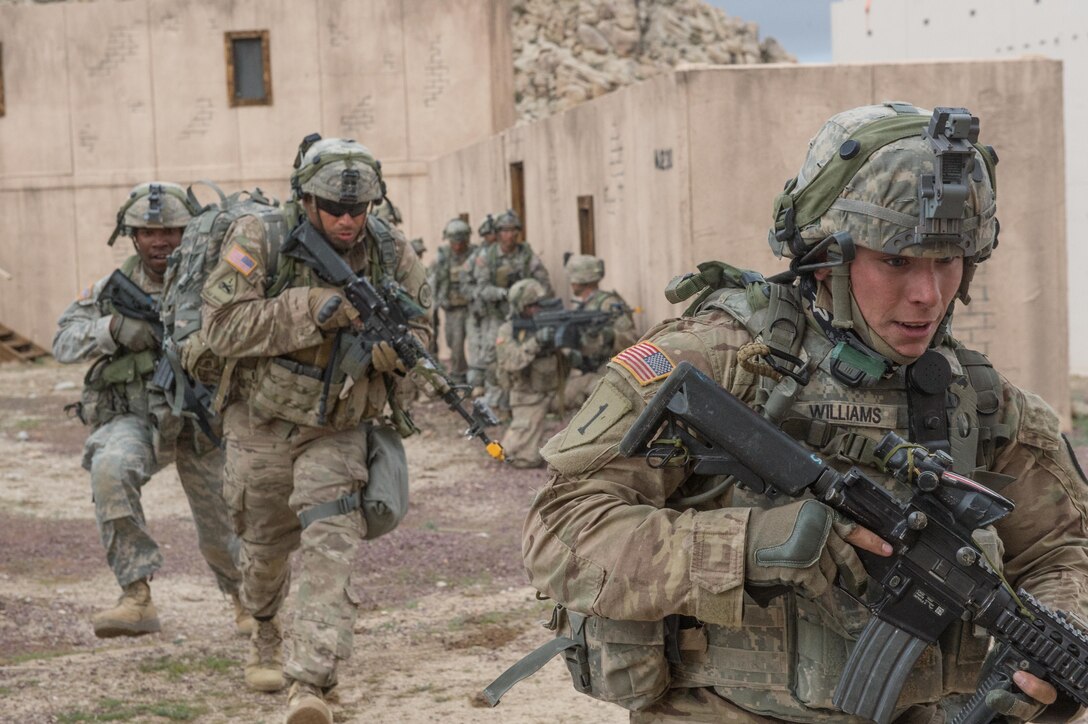 Soldiers maneuver to their follow-on fighting position during a clearance operation exercise in a mock town at the National Training Center, Fort Irwin, Calif., Feb. 18, 2016. U.S. Army photo by Staff Sgt. Alex Manne