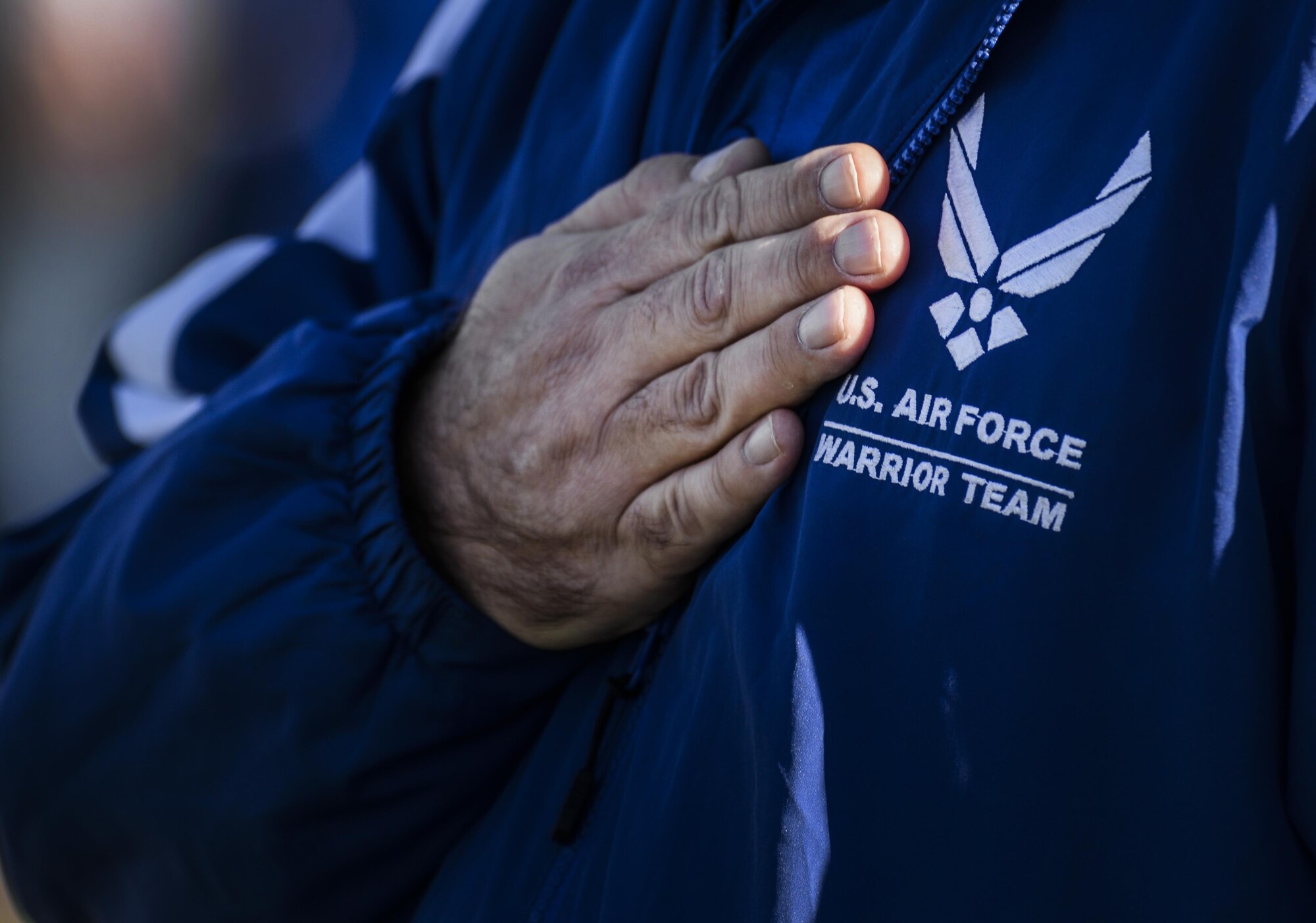 Member of the American Team hold his hand over his heart during the opening ceremonies at the 2016 Air Force Wounded Warrior Trials Feb. 26, at Nellis Air Force Base. More than 100 wounded, ill or injured service members from around the country along with their support teams have gathered for the Trials. (U.S. Air Force photo by Airman 1st Class Kevin Tanenbaum)