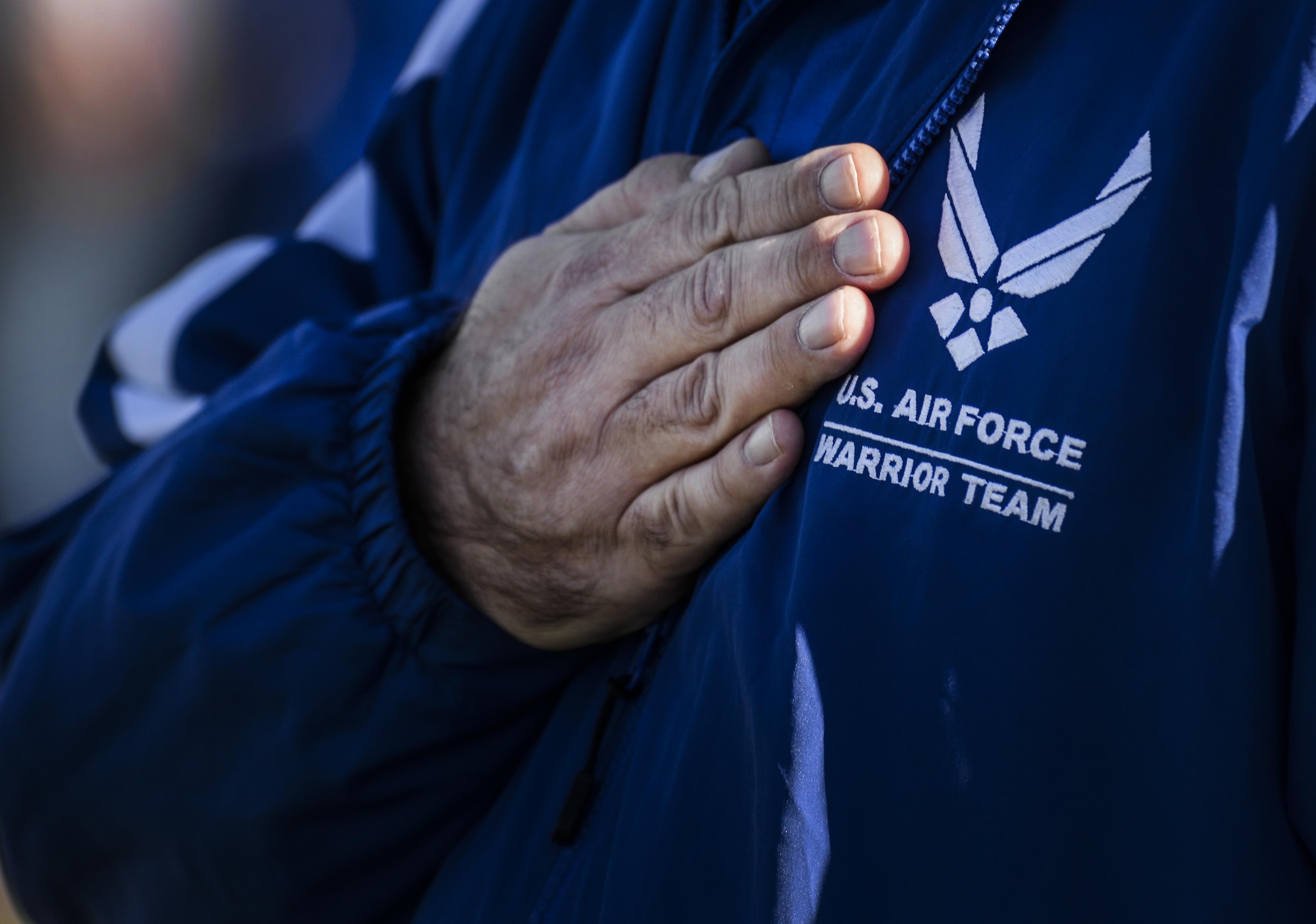 Member of the American Team hold his hand over his heart during the opening ceremonies at the 2016 Air Force Wounded Warrior Trials Feb. 26, at Nellis Air Force Base. More than 100 wounded, ill or injured service members from around the country along with their support teams have gathered for the Trials. (U.S. Air Force photo by Airman 1st Class Kevin Tanenbaum)