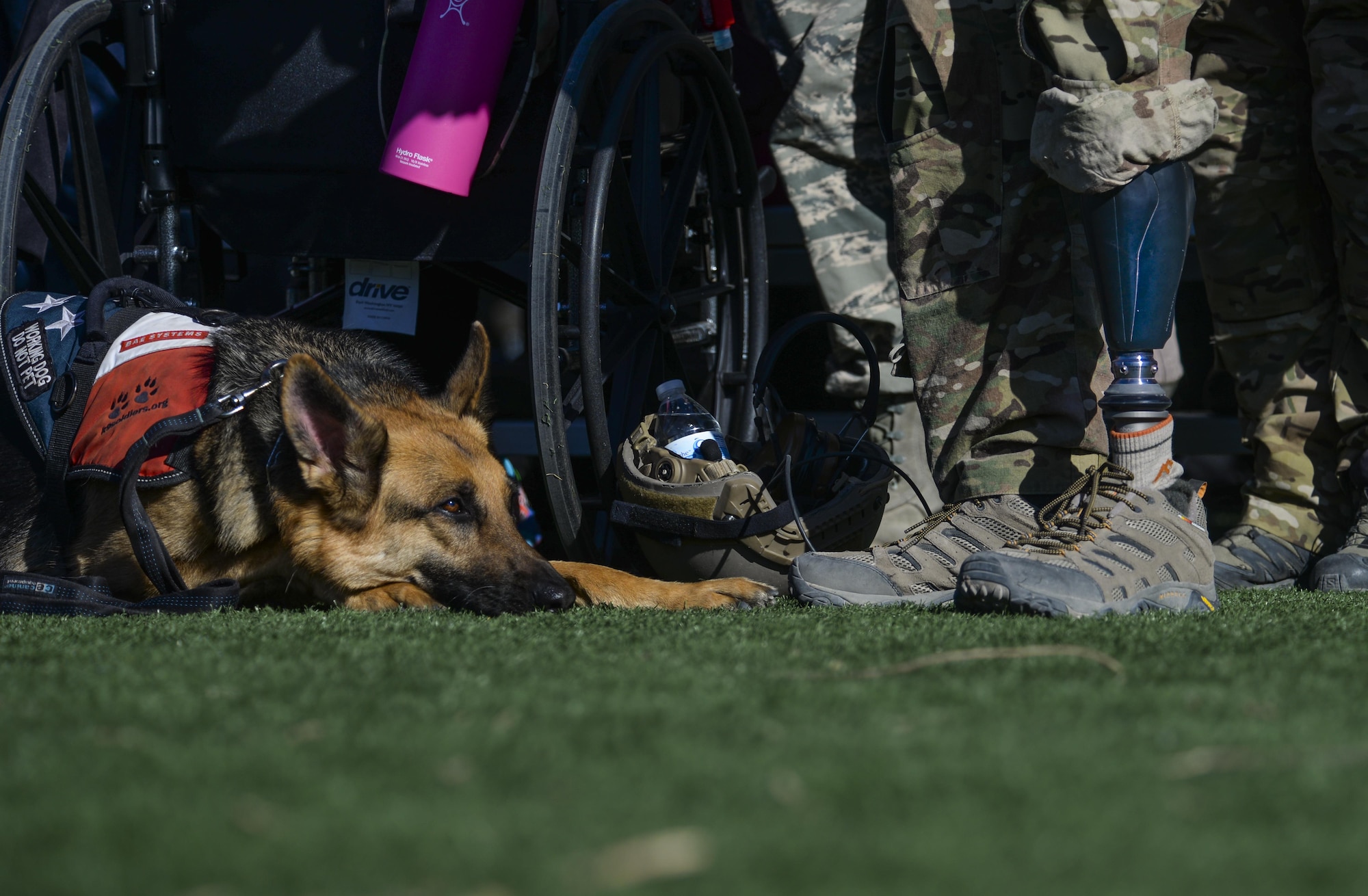 Staff Sgt. August O’Neill stands with his working dog during the opening ceremony of the 2016 Air Force Wounded Warrior Trials Feb. 26, at Nellis Air Force Base. Wounded warriors are encouraged to come out and try adaptive sports as a way to begin a new chapter within their life. (U.S. Air Force photo by Airman 1st Class Kevin Tanenbaum)
