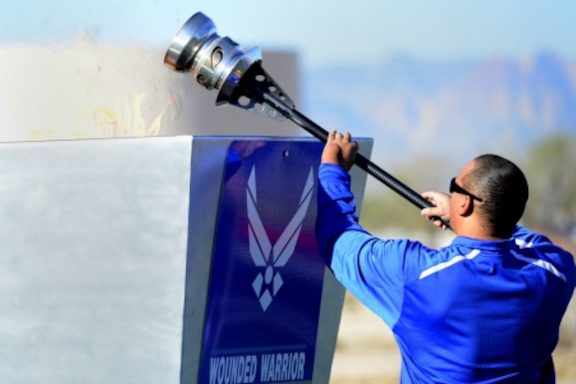 Technical Sgt. Brian Williams, Team USA Invictus Games competitor, lights the Air Force Wounded Warrior cauldron during the opening ceremony of the 2016 U.S. Air Force Trials at Nellis Air Force Base, Nev., Feb. 26. The Air Force Trials are an adaptive sports event designed to promote the mental and physical well-being of seriously wounded, ill and injured military members and veterans. More than 100 wounded, ill or injured service men and women from around the country will compete for a spot on the 2016 Warrior Games Team which will represent the Air Force at the US Military Academy at West Point in June. (U.S. Air Force photo by Staff Sgt. DeAndre Curtiss/Released)