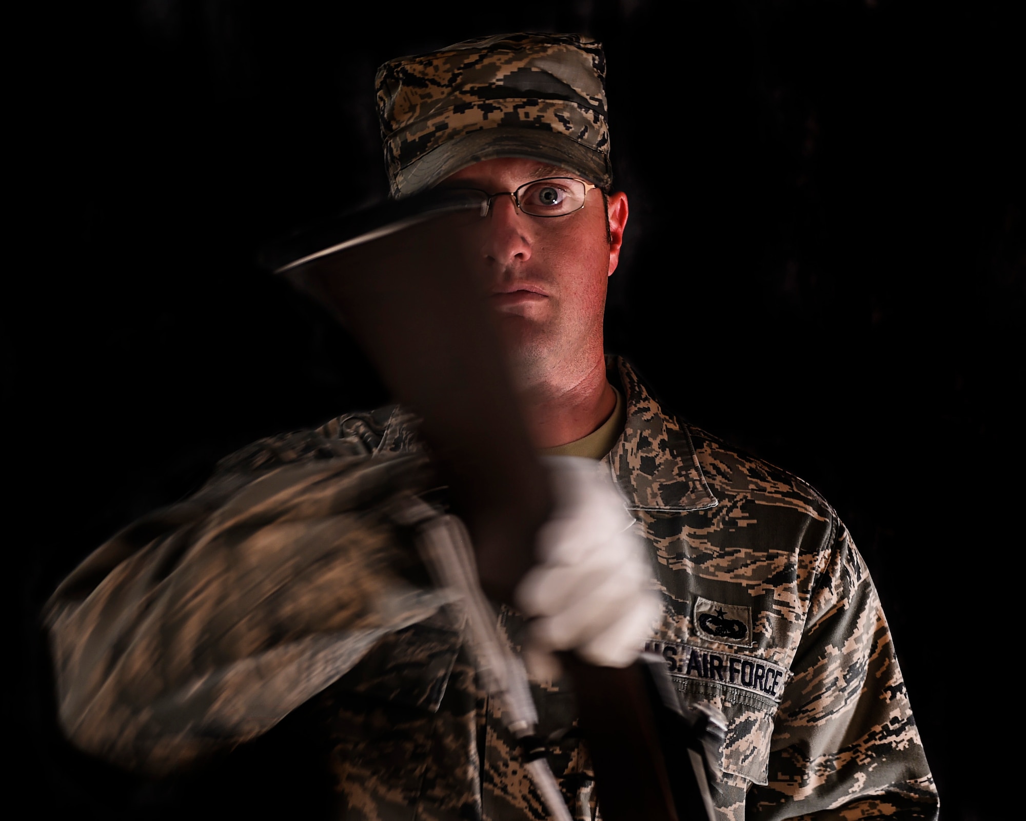 Tech. Sgt. Evan 432nd Wing/432nd Air Expeditionary Wing, Creech Ceremonial Team (CCT) NCOIC spins a rifle on Feb, 26. 2016. To provide a continuous level of support the CCT is made up 30-35 members who serve on a voluntary basis. They support a minimum of one detail per week but have had as many as four details in one duty day. (U.S. Air Force photo by Senior Airman Adarius Petty/released).