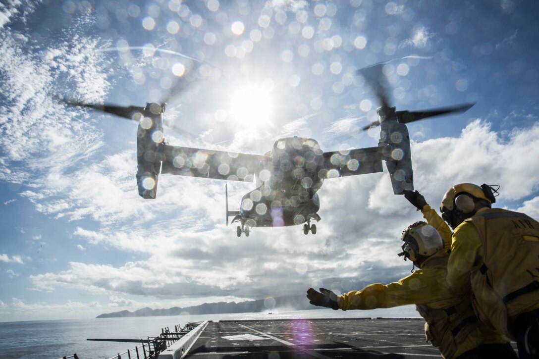 U.S. Navy Sailors with the Boxer Amphibious Ready Group signal the pilots of a U.S. Marine MV-22 Osprey during take off procedures aboard the USS New Orleans, at sea, Feb. 20, 2016. Aircraft handlers, along with the flight line section, ensure that aircraft land and take off safely. More than 4,500 Sailors and Marines from the Boxer Amphibious Ready Group, 13th Marine Expeditionary Unit team are currently transiting the Pacific Ocean toward the U.S. 7th Fleet area of operations during a scheduled deployment. (U.S. Marine Corps photo by Lance Cpl. Alvin Pujols/RELEASED)