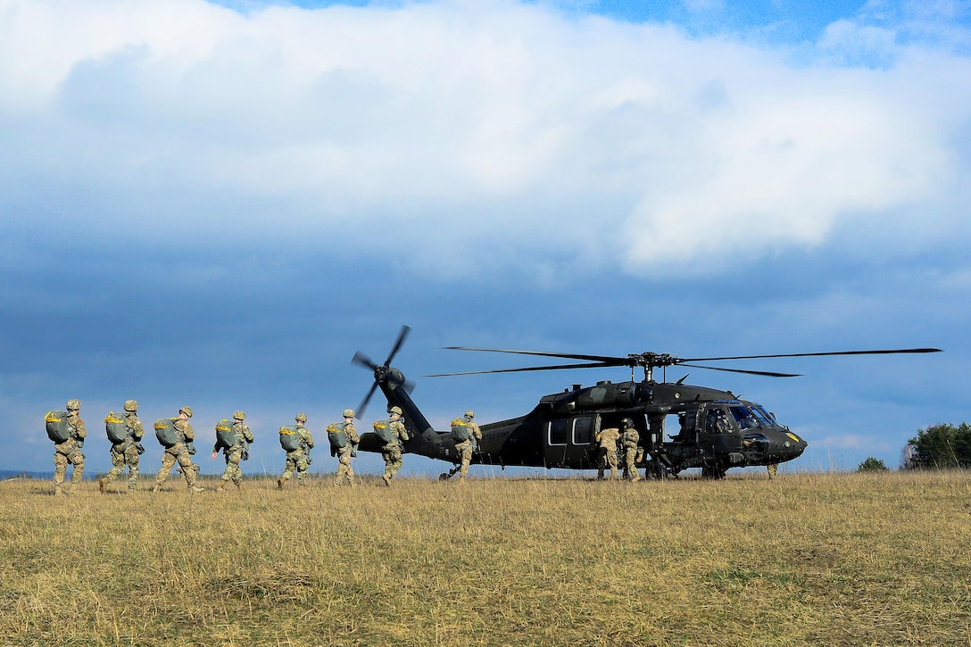 U.S. paratroopers prepare to load onto a UH-60 Black Hawk helicopter before participating in an airborne exercise over Grafenwoehr Training Area, Germany, Feb. 18, 2016. U.S. Army photo by Pfc. Emily Houdershieldt