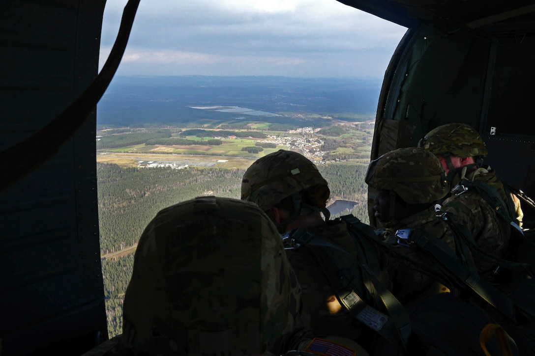 Paratroopers prepare to jump from a UH-60 Black Hawk helicopter during an airborne exercise over Grafenwoehr Training Area, Germany, Feb. 18, 2016. U.S. Army photo by Pfc. Emily Houdershieldt