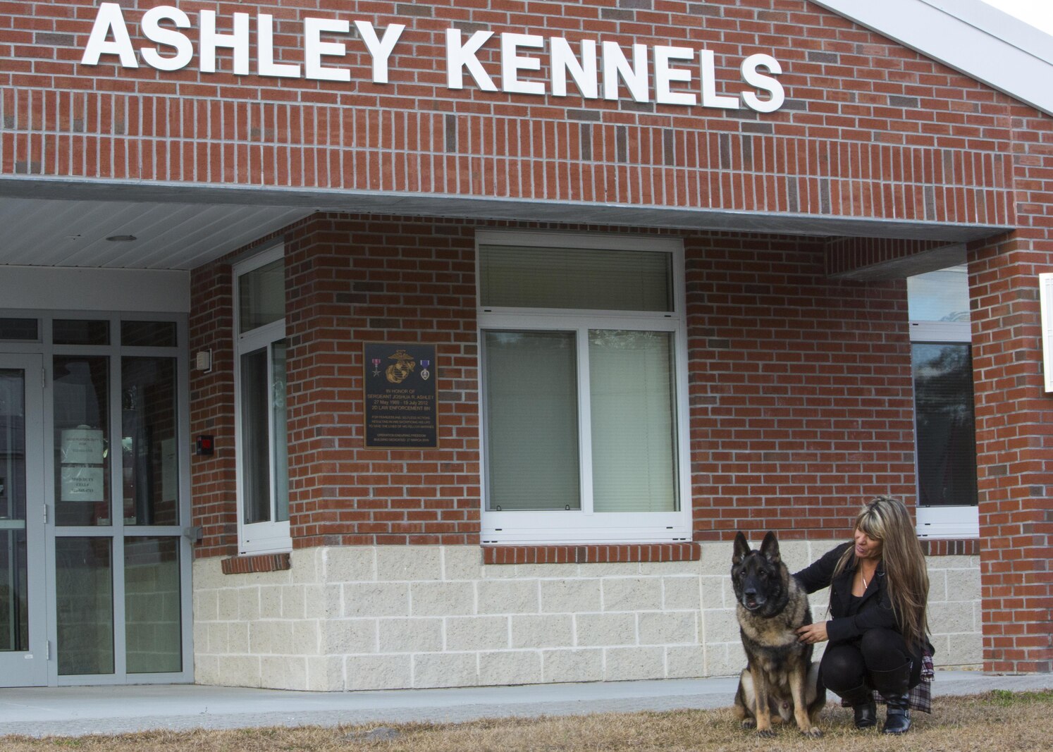 Tammie Ashley sits outside of the 2nd Law Enforcement Battalion kennels with her son’s former Military Working Dog, Sirius, at Camp Lejeune, N.C., Feb. 25, 2016. Tammie’s son and Sirius’ former handler, Sgt. Joshua Ashley, was killed while on patrol in 2012 in support of Operation Enduring Freedom, The Ashley family adopted Sirius after a passing of the leash retirement ceremony. (U.S. Marine Corps Photo by Cpl. Michelle Reif/Released.)