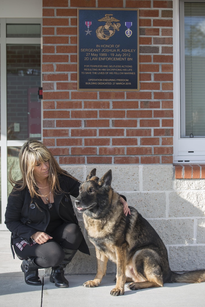 Tammie Ashley sits outside of the 2nd Law Enforcement Battalion kennels with her son’s former Military Working Dog, Sirius, at Camp Lejeune, N.C., Feb. 25, 2016. Tammie’s son and Sirius’ former handler, Sgt. Joshua Ashley, was killed while on patrol in 2012 in support of Operation Enduring Freedom. The Ashley family adopted Sirius after a passing of the leash retirement ceremony. (U.S. Marine Corps Photo by Lance Cpl. Erick Galera/Released.)