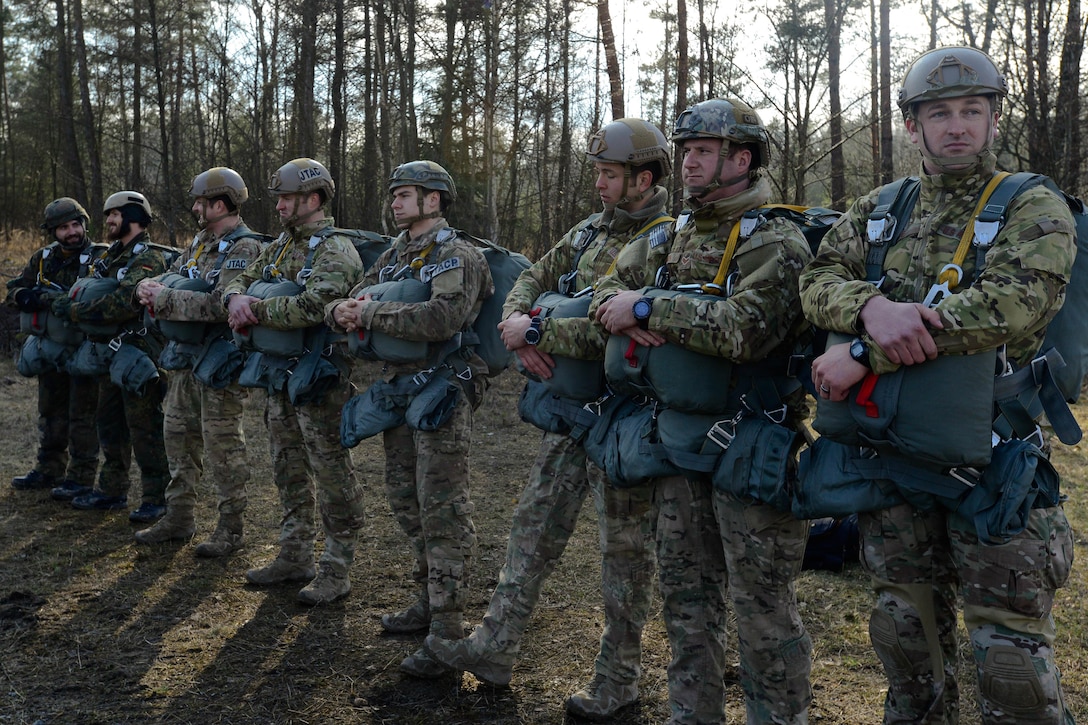 U.S. paratroopers, airmen, and German soldiers prepare to load onto a UH-60 Black Hawk helicopter as part an airborne exercise over Grafenwoehr Training Area, Germany, Feb. 18, 2016. The airmen are joint terminal attack controllers. U.S. Army photo by Pfc. Emily Houdershieldt