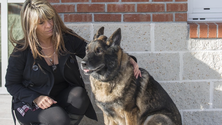 Tammie Ashley sits outside of the 2nd Law Enforcement Battalion kennels with her son’s former Military Working Dog, Sirius, at Marine Corps Base Camp Lejeune, N.C., Feb. 25, 2016. Tammie’s son and Sirius’ former handler, Sgt. Joshua Ashley, was killed while on patrol in 2012 in support of Operation Enduring Freedom. The Ashley family adopted Sirius after a passing of the leash retirement ceremony.