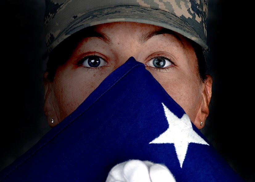 Senior Airman Kimberly, 432nd Wing/432nd Air Expeditionary Wing, Creech Ceremonial Team member holds a flag on Feb, 26. 2016. To provide a continuous level of support the Creech Ceremonial Team is made up 30-35 members who serve on a voluntary basis. They maintain a minimum of one detail per week but have had as many as four details in one duty day. (U.S. Air Force photo by Senior Airman Adarius Petty/released).