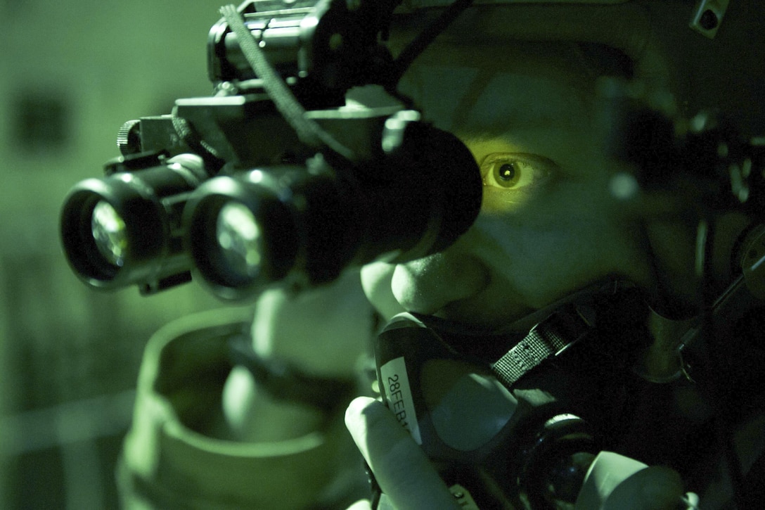 Air Force Senior Airman Noah Lindquist tests his night vision goggles in the back of a C-130J Super Hercules aircraft before a sortie on Bagram Airfield, Afghanistan, Feb. 22, 2016. Air Force photo by Tech. Sgt. Robert Cloys

