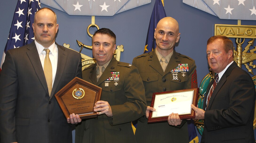 Lt. Col. Michael Wendler (left), commander of Combat Logistics Battalion 453, 4th Marine Logistics Group, Marine Forces Reserve, and Sgt. Maj. Larry Trimmer (right), battalion sergeant major of CLB-453, 4th MLG, accept the Reserve Family Readiness Award on behalf of their family readiness teams during an awards ceremony at the Pentagon Hall of Heroes in Arlington, Va., Feb. 26, 2016. 