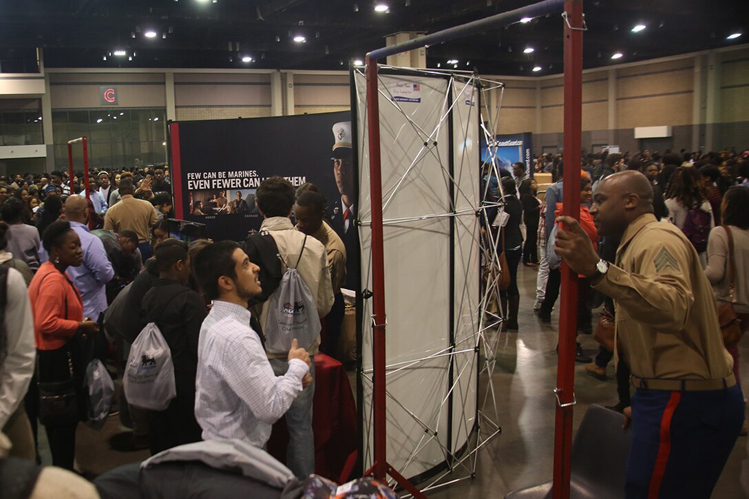 Marines from the surrounding areas challenge the students participating in the Central Intercollegiate Athletic Association (CIAA) High School Education Day to chin-up challenges while also informing them all of the opportunities the Marine Corps can give them at the Charlotte Convention Center on Feb. 24, 2016. High school students from around the Charlotte area participated in the event to learn about career and education opportunities. The Marine Corps has participated in CIAA events for more than 15 years and will be present for the 2016 CIAA basketball tournament. (Official Marine Corps Photo by Cpl. John-Paul Imbody)