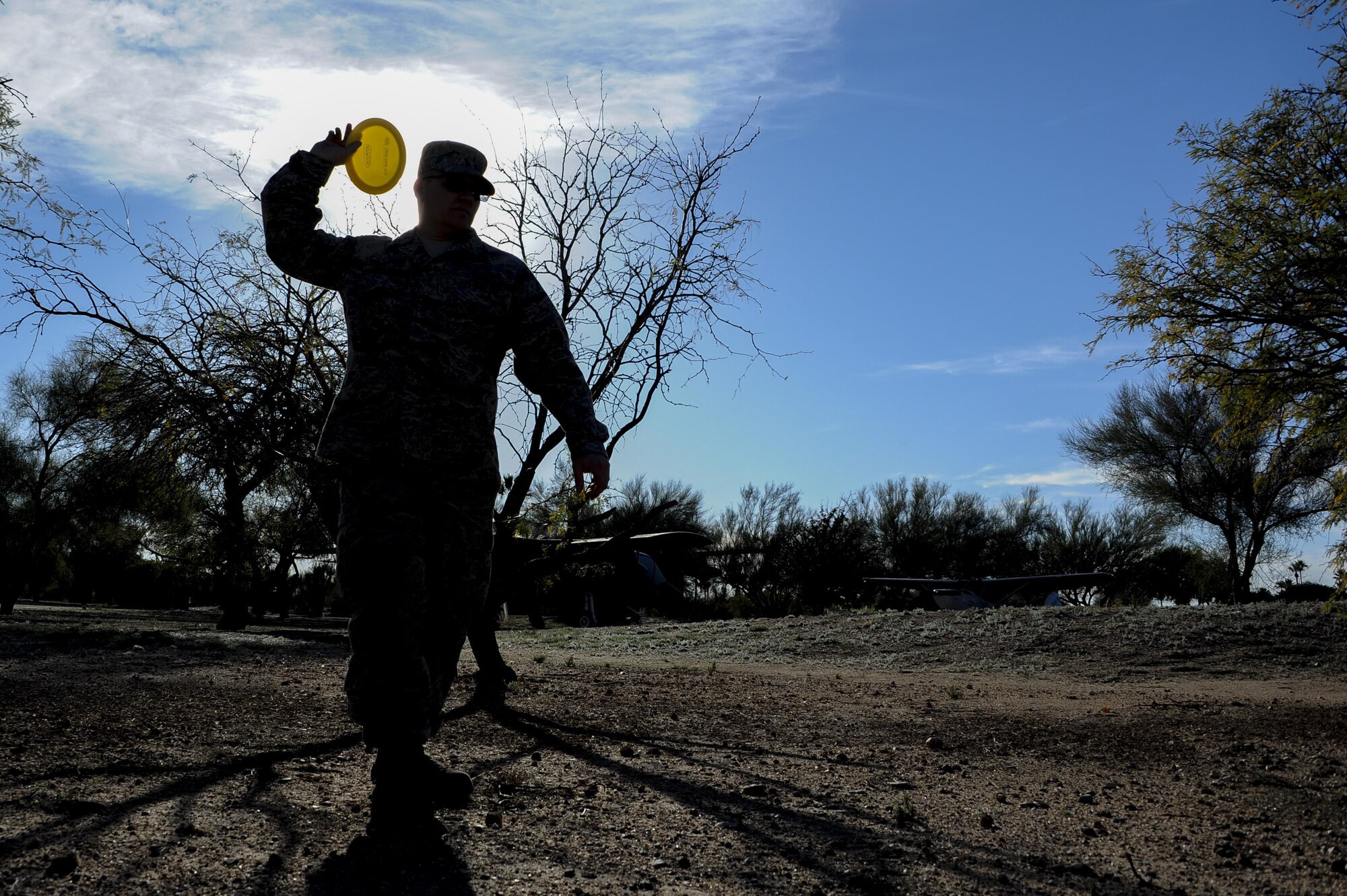 U.S. Air Force Tech. Sgt. Donald Brown, 355th Electronic Maintenance Squadron C-130 dock coordinator, lines up an overhand disc golf shot at Heritage Park near the future disc golf course site at Davis-Monthan Air Force Base, Ariz., Feb. 10, 2016. Doub and Tech. Sgt. Donald Brown, 355th Electronic Maintenance Squadron C-130 dock coordinator, designed a disc golf course and proposed their idea during a Innovate DLT event. (U.S. Air Force photo by Airmen 1st Class Ashley N. Steffen/Released)