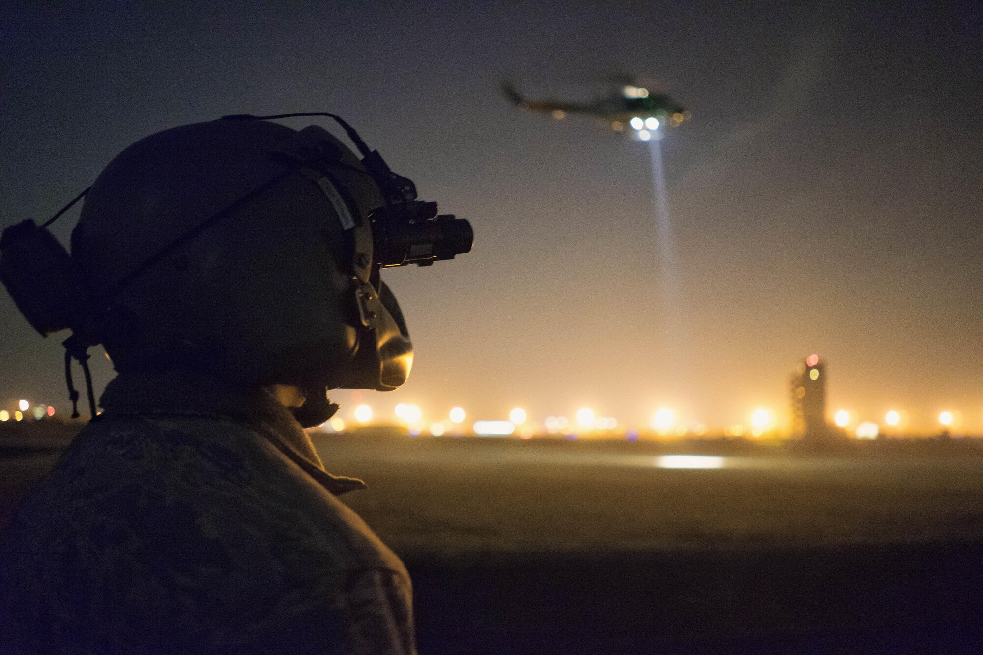 Tech. Sgt. Michael Wright, 459th Airlift Squadron UH-1N Huey flight engineer, watches as a UH-1N prepares to lift a stokes litter at Yokota Air Base, Japan, Feb. 23, 2016. The 459th AS recently improved their search and rescue capabilities by outfitting two Hueys with new rescue hoists. Previously, without the hoist, conducting rescues in small, tight areas wasn’t feasible. Now, 459th AS aircrew can conduct any type of search and rescue scenario throughout the Kanto Plains. (U.S. Air Force photo by Airman 1st Class Delano Scott/Released)