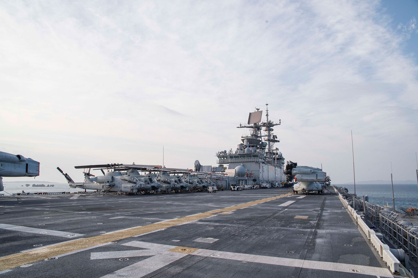 160229-N-XK809-076 WHITE BEACH, Okinawa (Feb. 29, 2016) - Amphibious assault ship USS Bonhomme Richard (LHD 6) departs White Beach, Okinawa after embarking Expeditionary Strike Group (ESG) 7. Bonhomme Richard is the flagship of the Bonhomme Richard Expeditionary Strike Group (BHRESG), assigned to ESG 7, Task Force 76, and is conducting a routine patrol in the 7th Fleet area of responsibility. (U.S. Navy photo by Mass Communication Specialist Seaman William Sykes/Released)
