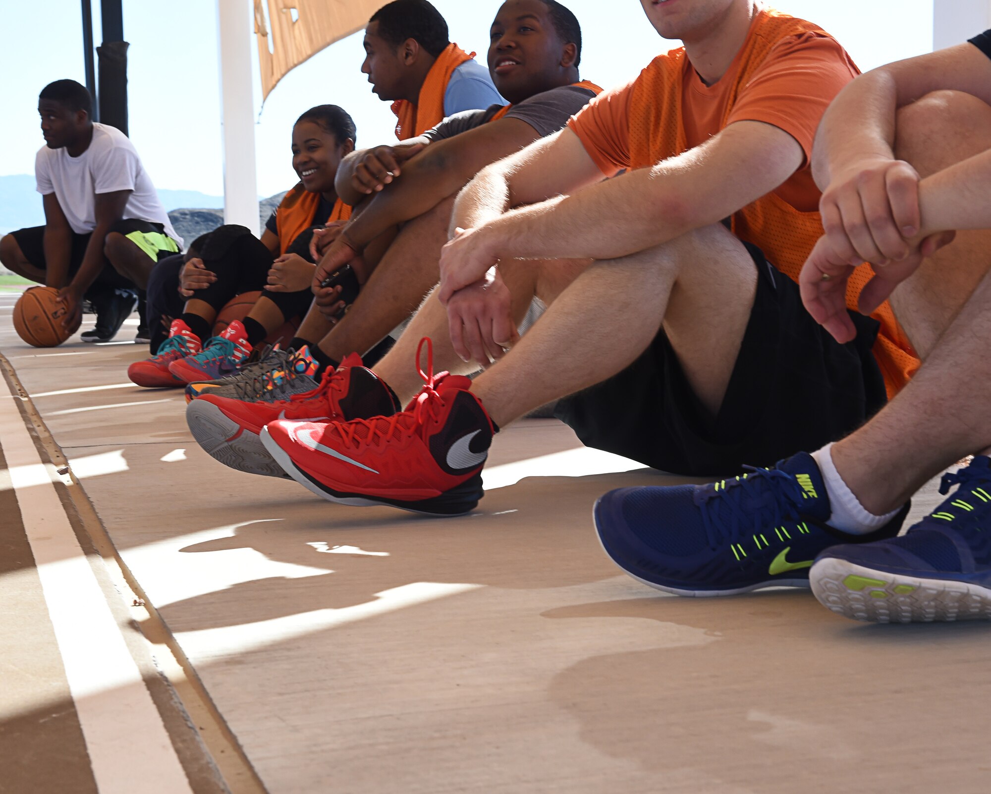 Airmen assigned to the 432nd Wing/432nd Air Expeditionary Wing and the 799th Air Base Group watch other teams play during a three-on-three basketball tournament Feb. 26, 2016, at Creech Air Force Base, Nevada. This tournament promotes friendly competition as well as camaraderie. (U.S. Air Force photo by Senior Airman Adarius Petty/Released)