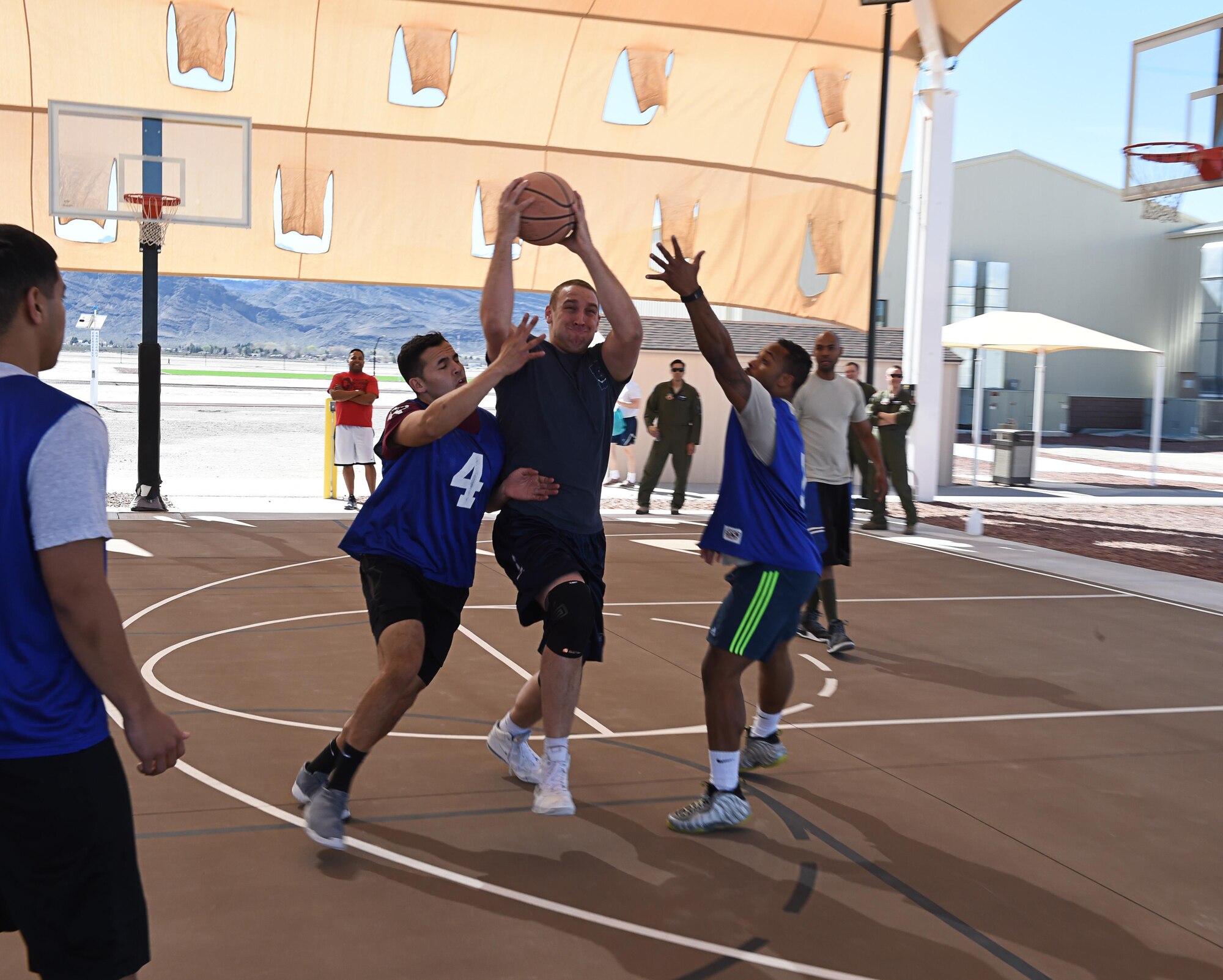 Capt. Ryan, 432nd Wing intelligence officer competes in a three-on-three basketball tournament Feb. 26, 2016, at Creech Air Force Base, Nevada. Due to the intense operations requirements this provides a networking opportunity for Airmen as well as allow them to engage in physical activity. (U.S. Air Force photo by Senior Airman Adarius Petty/Released)