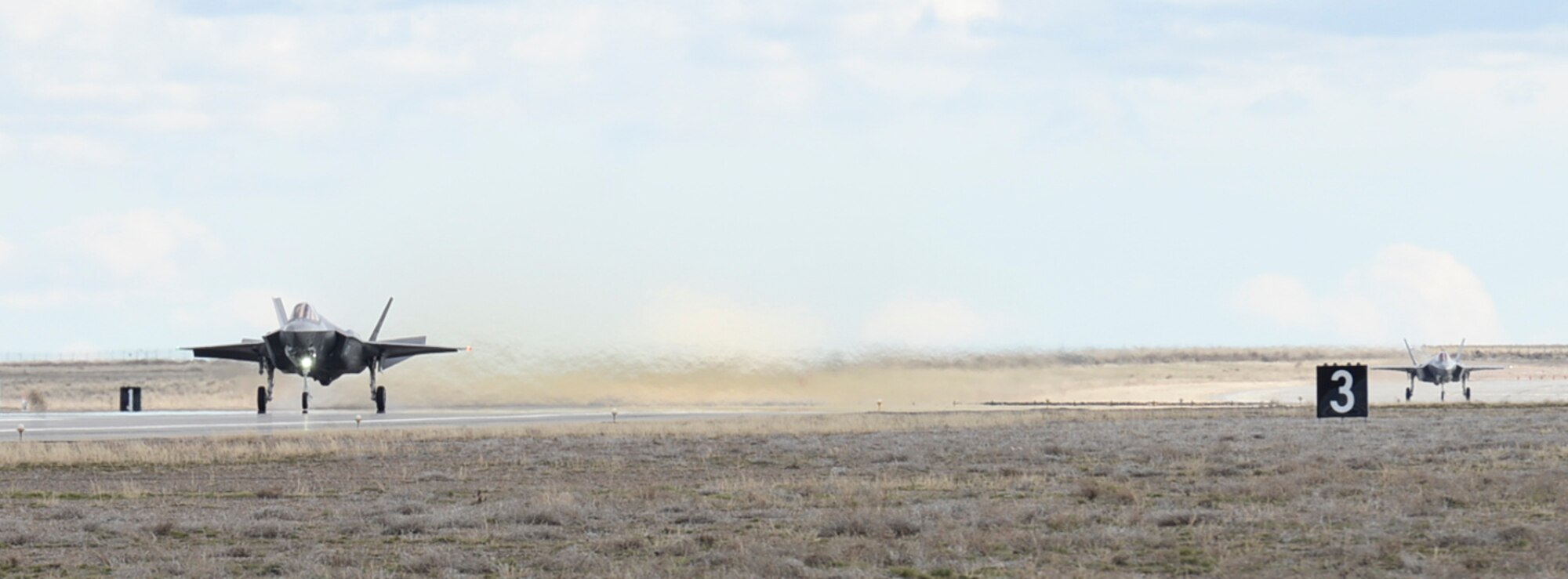 Two F-35As begin their take-off from Mountain Home Air Force Base, Idaho, Feb. 18, 2016. Six F-35s are here to begin an operational deployment test at the nearby range complex. (U.S. Air Force photo by Airman 1st Class Jessica H. Evans/RELEASED)