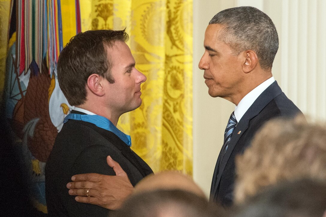 President Barack Obama congratulates Navy Senior Chief Petty Officer Edward C Byers Jr. during a ceremony in which Obama presented Byers with the Medal of Honor at the White House in Washington, D.C. Feb. 29, 2016. DoD photo by EJ Hersom