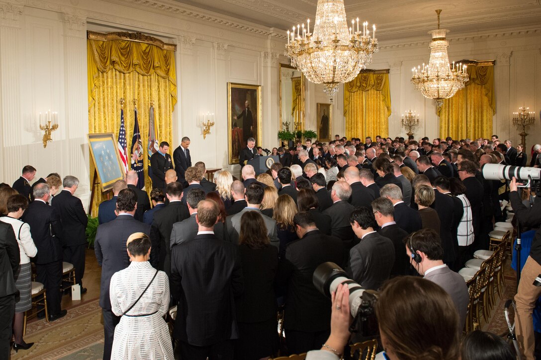 President Barack Obama and Navy Senior Chief Petty Officer Edward C Byers Jr. say a prayer before Obama presents Byers with the Medal of Honor during a ceremony at the White House in Washington, D.C. Feb. 29, 2016. Byers received the medal for his actions while serving as part of a team that rescued an American civilian held hostage in Afghanistan in 2012. DoD photo by EJ Hersom