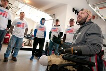 U.S. Army Sgt. (ret.) Adam Keys expresses his gratitude to a group of 459th Aircraft Maintenance Squadron members at his home in Annapolis Feb. 27, 2016. Ten members of the 459th AMXS volunteered on behalf of the nonprofit Patriots Honor to unpack, build and install workbenches, power tools and roll-aways in Keys’ garage in effort to help make dreams come true for wounded warriors. Keys, a triple amputee who has endured more than 130 surgeries due to injuries sustained from an IED explosion in Afghanistan in 2010, intends to use the equipment to pursue his hobby of building small engines and model cars. (U.S. Air Force photo by Staff Sgt. Kat Justen)