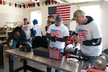 459th Aircraft Maintenance Squadron members unbox power tools in U.S. Army Sgt. (ret.) Adam Keys’ garage in Annapolis Feb. 27, 2016. Ten members of the 459th AMXS volunteered on behalf of the nonprofit Patriots Honor to unpack, build and install workbenches, power tools and roll-aways in Keys’ garage in effort to help make dreams come true for wounded warriors. Keys, a triple amputee who has endured more than 130 surgeries due to injuries sustained from an IED explosion in Afghanistan in 2010, intends to use the equipment to pursue his hobby of building small engines and model cars. (U.S. Air Force photo by Staff Sgt. Kat Justen)