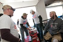 Senior Master Sgt. Bradley Otey, 459th Aircraft Maintenance Squadron flight chief (left), shares a laugh with U.S. Army Sgt. (ret.) Adam Key (right) as other 459th members unbox power tools in Keys’ garage in Annapolis Feb. 27, 2016. Ten members of the 459 AMXS volunteered on behalf of the nonprofit Patriots Honor to unpack, build and install workbenches, power tools and roll-aways in Keys’ garage in an effort to help make dreams come true for Wounded Warriors. Keys, a triple amputee who has endured more than 130 surgeries due to injuries sustained from an IED explosion in Afghanistan in 2010, intends to use the equipment to pursue his hobby of building small engines and model cars. (U.S. Air Force photo by Staff Sgt. Kat Justen)